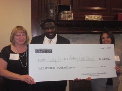 Tindley Collegiate Academy Girls School was named the 2013 Impact 100 Greater Indianapolis $100,000 grant winner on Tuesday. Pictured, left to right, are Dr. Dina Stephens, Chief Academic Officer, Marcus C. Robinson, CEO, and Kelli B. Marshall, Principal.